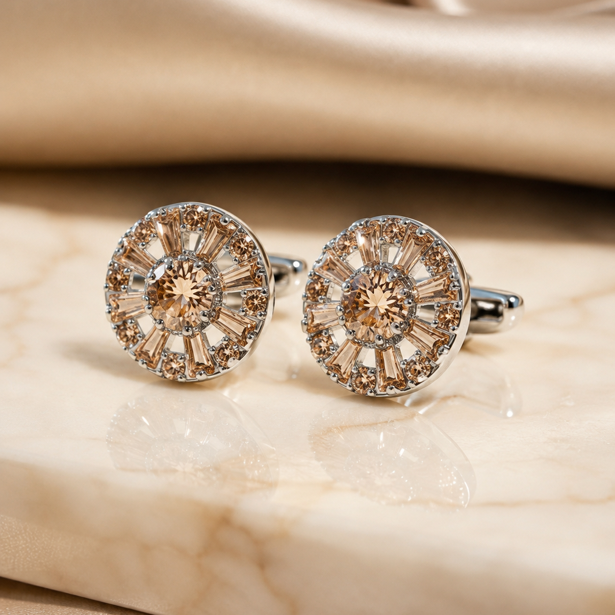 Orlando cufflink with a warm champagne centre stone surrounded by tapered baguettes and small round stones in a silver-tone sunburst