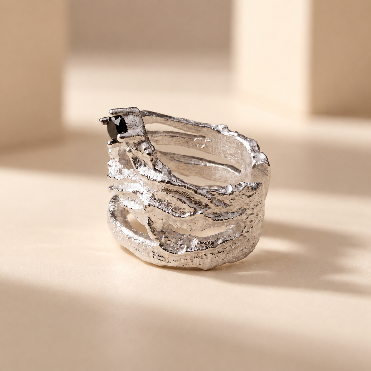 Meteorite sculptural sterling silver ear cuff with black cubic zirconia, worn on the upper ear