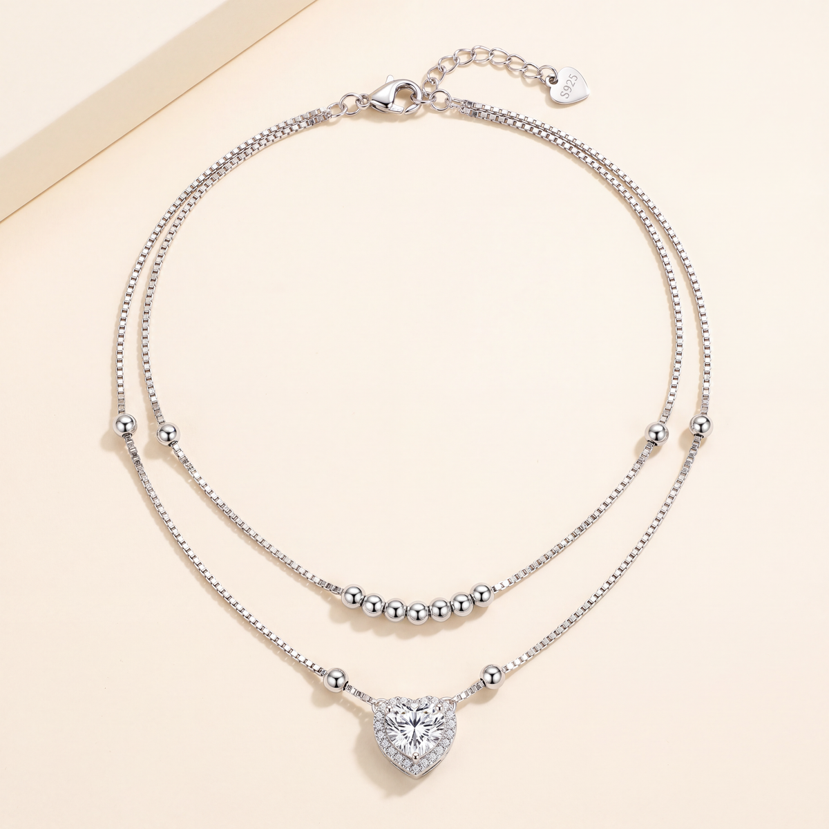 Close up of the polished sterling silver beads on the box chain of the Juliet layered necklace