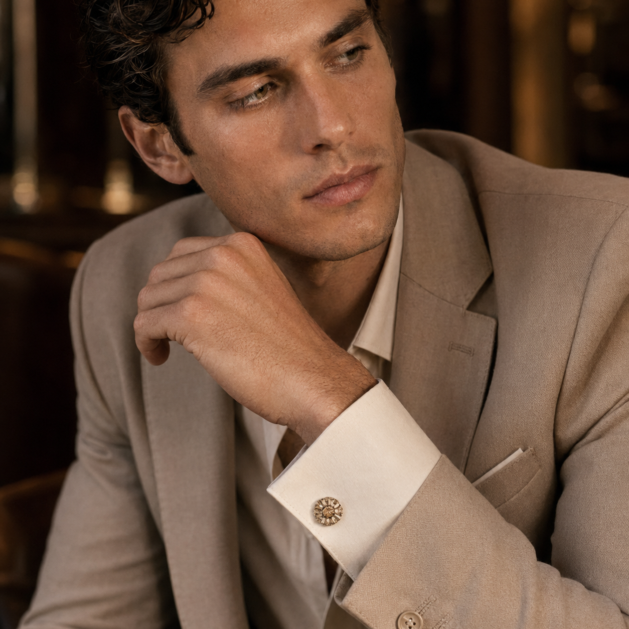 Orlando champagne cufflink shown at an angle, with the swivel bar fastening visible behind the sunburst face