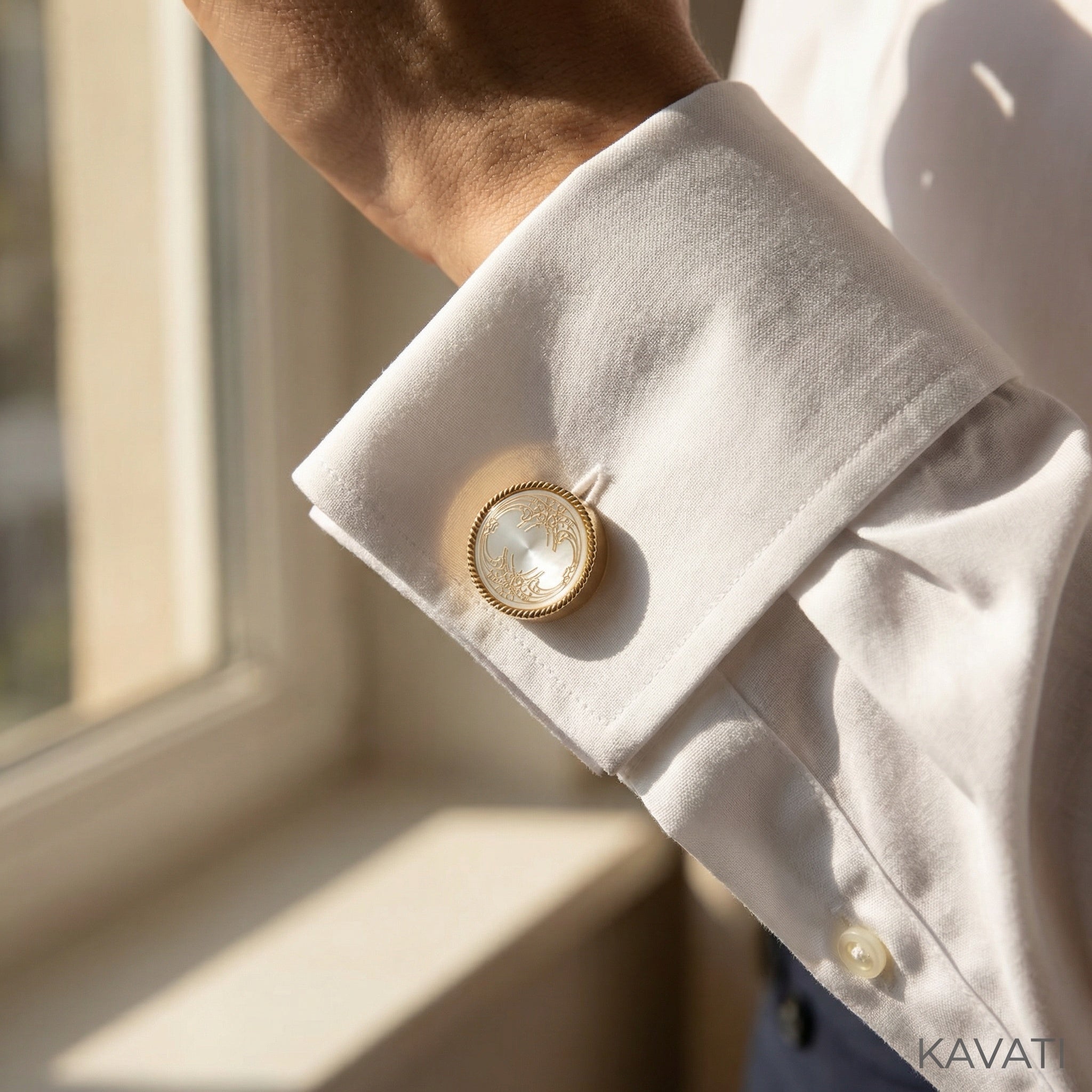 Close up of the engraved vintage pattern on a white enamel cufflink