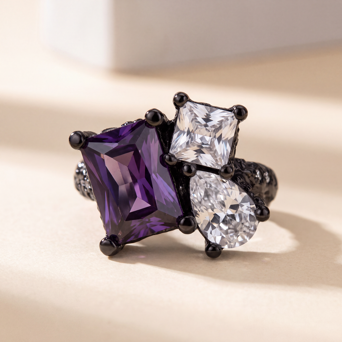 Side view of the black Dewdrop Ear Cuff showing the pear-cut purple stone and open cuff band