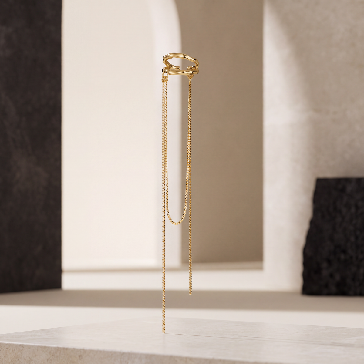 Golden Rain gold tassel ear cuff seen from the side, two fine box chains at 13 cm and 11 cm falling from the open hoop