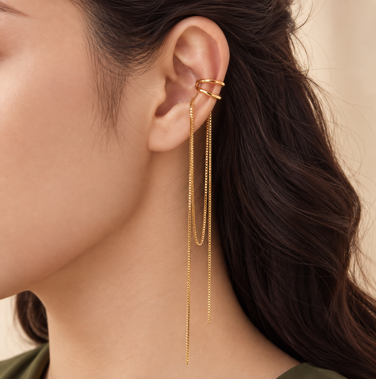 Close-up of the Golden Rain Ear Cuff worn on the upper ear, gold double hoop on the cartilage with two box chains falling past the jaw