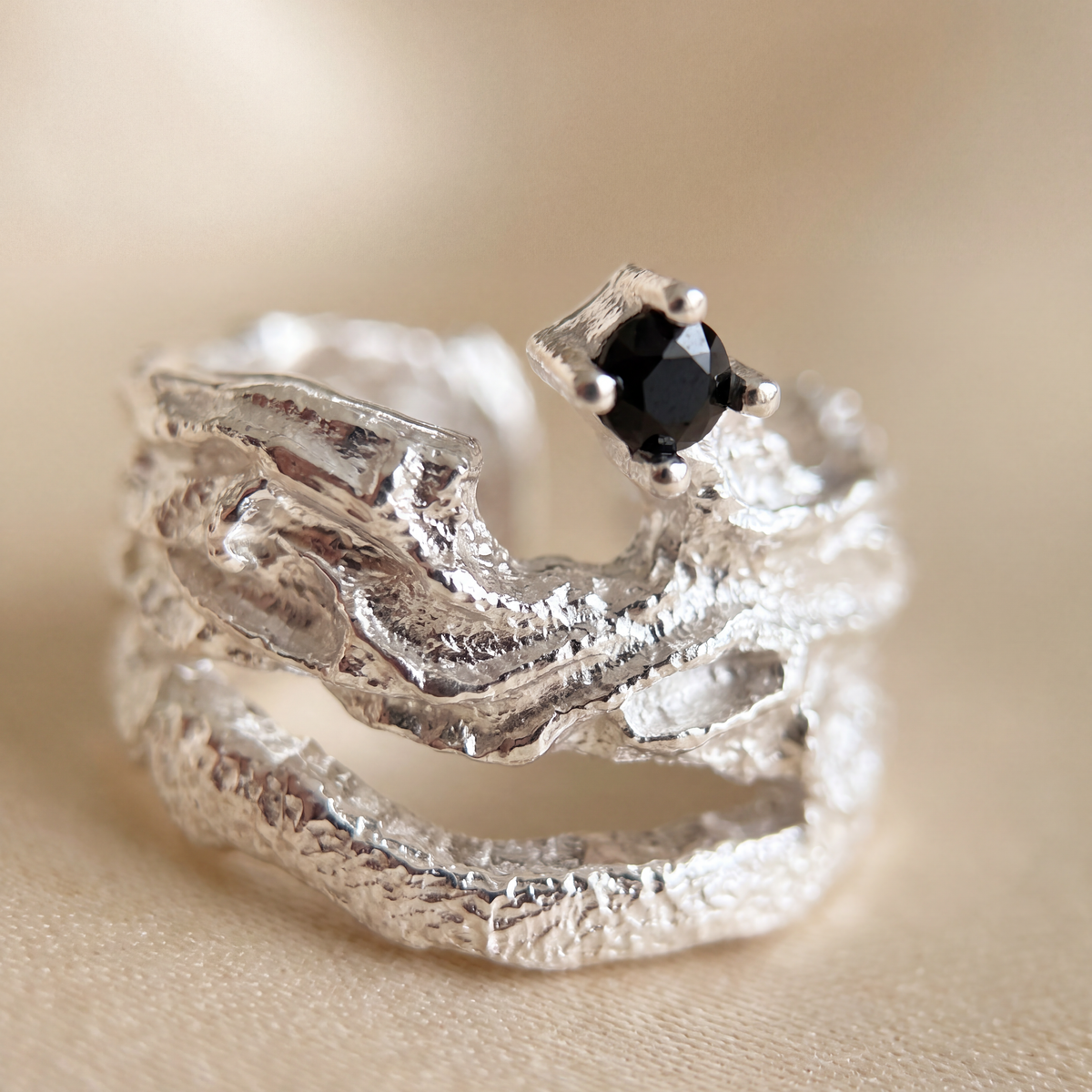 Side view of the Meteorite sterling silver ear cuff with its open adjustable band